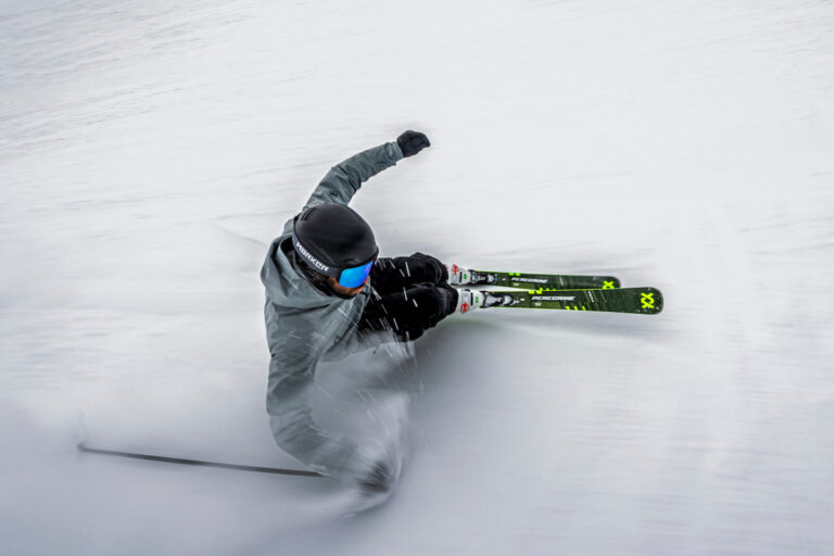 man on park city sport ski rentals carving a turn