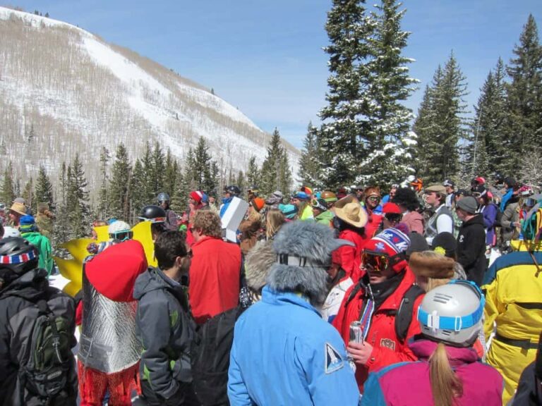 Clown Day at Park City Mountain with a big crowd of skiers and snowboarders at an on mountain party