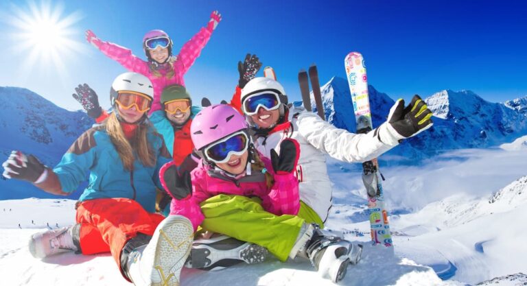 Smiling Park City family posing with their ski rentals