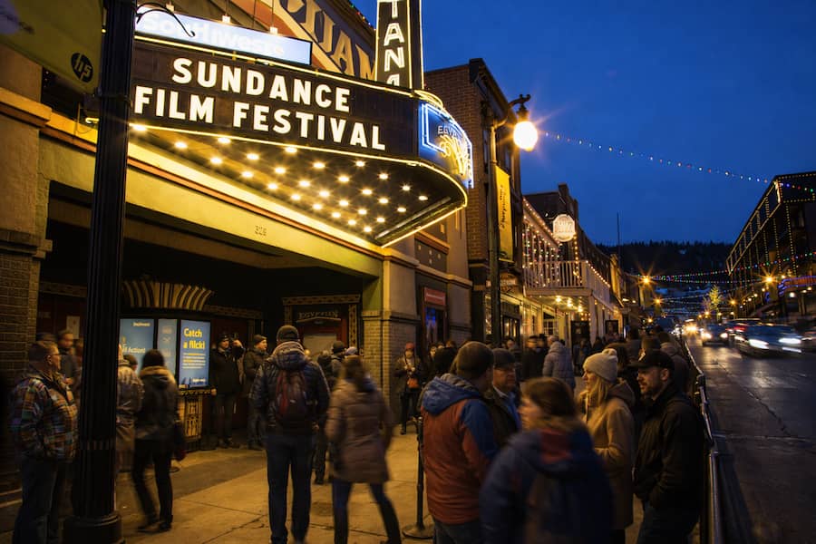Sundance Film Festival sign with people on main street after a day of skiing