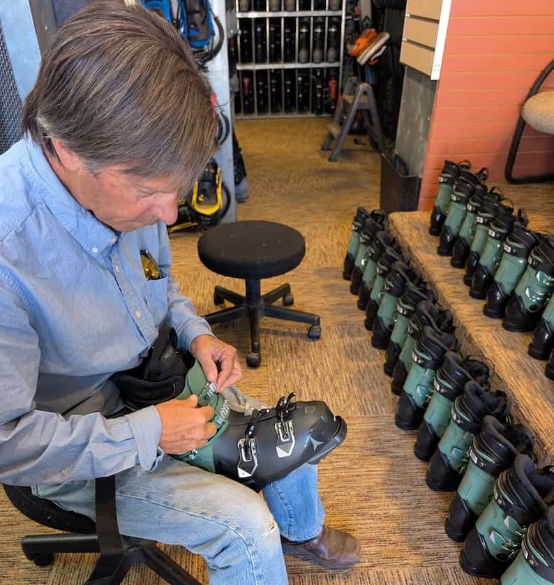 Dean, the owner of Park City Sport, fitting ski boot rentals